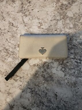 kate spade cream leather wristlet with black strap